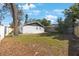 Spacious backyard showcasing a lush lawn, mature trees, and a private setting at 509 13Th Nw Ave, Largo, FL 33770