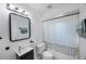 Updated bathroom features modern vanity, black framed mirror and bathtub at 509 13Th Nw Ave, Largo, FL 33770