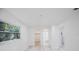 Bright bedroom with light gray wood-look floors and a view to closet and bathroom at 509 13Th Nw Ave, Largo, FL 33770