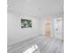 Bright bedroom featuring wood-look flooring and a closet and bathroom entrances at 509 13Th Nw Ave, Largo, FL 33770