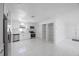 Well-lit kitchen showcasing stainless steel appliances, white cabinetry, and new flooring at 509 13Th Nw Ave, Largo, FL 33770