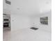 Bright living room features white floors and a view to the kitchen at 509 13Th Nw Ave, Largo, FL 33770