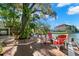 Waterfront backyard featuring deck area with outdoor seating and serene canal views at 550 7Th S St, Safety Harbor, FL 34695