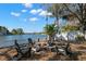 Backyard with a waterfront firepit area, seating, and scenic water views at 550 7Th S St, Safety Harbor, FL 34695