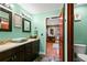 Bright bathroom with dual sinks, dark wood cabinets, and a decorative accent wall at 550 7Th S St, Safety Harbor, FL 34695