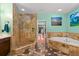 Luxurious bathroom features a standalone shower, jetted tub, and elegant stone finishes at 550 7Th S St, Safety Harbor, FL 34695