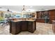 Bright, open kitchen flows into the living area with custom cabinets, natural stone countertops, and ample storage space at 550 7Th S St, Safety Harbor, FL 34695