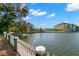 Stunning lake view showcasing waterfront homes, a white picket fence, and lush greenery at 550 7Th S St, Safety Harbor, FL 34695