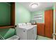 Functional laundry room with washer, dryer, storage cabinets, and tile floors at 550 7Th S St, Safety Harbor, FL 34695
