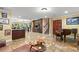 Open-concept living area with custom tile floors, a wet bar, recessed lighting, decorative columns, and classic design features at 550 7Th S St, Safety Harbor, FL 34695