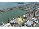 Aerial view of the property situated on a canal with easy access to the bay at 575 Crystal Dr, Madeira Beach, FL 33708
