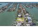 An aerial shot of a vacant lot with waterfront access, surrounded by homes at 575 Crystal Dr, Madeira Beach, FL 33708