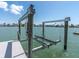 A sturdy boat lift, part of a private dock, on a serene waterfront property with scenic views at 575 Crystal Dr, Madeira Beach, FL 33708