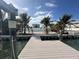 View from the private dock of the backyard pool and surrounding homes at 575 Crystal Dr, Madeira Beach, FL 33708