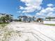 Wide angle view of a vacant lot ready for new construction in a waterfront community at 575 Crystal Dr, Madeira Beach, FL 33708