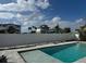Backyard pool and privacy fence with views of other homes in the neighborhood at 575 Crystal Dr, Madeira Beach, FL 33708