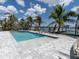 Beautifully designed swimming pool with a spa overlooks a scenic waterfront and boat dock at 575 Crystal Dr, Madeira Beach, FL 33708