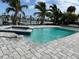 A beautiful pool and outdoor patio with views of the bay and private dock at 575 Crystal Dr, Madeira Beach, FL 33708