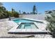 Sparkling pool and spa combination, beautifully surrounded by a paved patio area and white privacy fence at 575 Crystal Dr, Madeira Beach, FL 33708