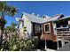 Quirky restaurant exterior with a shark-themed design, inviting atmosphere, and tropical landscaping at 575 Crystal Dr, Madeira Beach, FL 33708