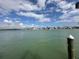 Picturesque waterfront view showcasing charming houses across the tranquil bay and cloudy sky at 575 Crystal Dr, Madeira Beach, FL 33708