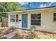 Charming home featuring a beautiful blue front door, bay window, and well-maintained landscaping at 599 71St N Ave, St Petersburg, FL 33702