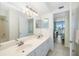 Bright bathroom with double sinks, shower, and access to the beautiful views from the room at 6061 Bahia Del Mar Cir # 442, St Petersburg, FL 33715