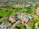 Overhead view of community clubhouse, swimming pool, golf course, and colorful landscaping at 6762 Pearleaf Ct, Spring Hill, FL 34606