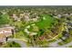 Aerial view of a well-manicured golf course with sand traps surrounded by lush greenery and homes at 6762 Pearleaf Ct, Spring Hill, FL 34606