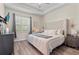 Serene bedroom with a tufted headboard, soft lighting, and a window view, creating a peaceful retreat at 7240 102Nd Ln, Seminole, FL 33772