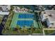 Aerial view of well-maintained tennis courts next to waterfront property at 7645 Sun Island S Dr # 201, South Pasadena, FL 33707