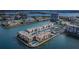 Stunning aerial view of waterfront condos with a pristine pool, lush landscaping, and convenient covered parking at 7645 Sun Island S Dr # 201, South Pasadena, FL 33707