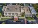 View of the building's exterior, showing balconies, green spaces, and parking area at 7645 Sun Island S Dr # 201, South Pasadena, FL 33707