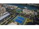 Aerial view of the tennis courts and buildings, showing the waterfront and parking at 7645 Sun Island S Dr # 201, South Pasadena, FL 33707