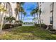 Lush backyard providing water view and featuring tropical landscaping at 7645 Sun Island S Dr # 201, South Pasadena, FL 33707