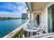 Enjoy stunning waterfront views from this inviting balcony with table and chairs at 7645 Sun Island S Dr # 201, South Pasadena, FL 33707