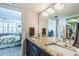 Updated bathroom featuring a double sink with granite countertops and access to the bedroom at 7645 Sun Island S Dr # 201, South Pasadena, FL 33707