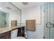 Modern bathroom with gray tiling, an elegant glass shower, and granite countertops at 7645 Sun Island S Dr # 201, South Pasadena, FL 33707