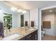 Double vanity bathroom featuring light-colored countertops and dark cabinets, with access to the closet at 7645 Sun Island S Dr # 201, South Pasadena, FL 33707