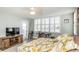 Bedroom featuring a workspace, intercoastal views, white shutters and a wood style television cabinet at 7645 Sun Island S Dr # 201, South Pasadena, FL 33707