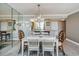 Dining room view to kitchen with decorative mirror and modern chandelier at 7645 Sun Island S Dr # 201, South Pasadena, FL 33707