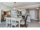 Light and airy dining room with a view of the kitchen area and large mirror at 7645 Sun Island S Dr # 201, South Pasadena, FL 33707