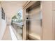 A stainless-steel elevator providing easy access to different floors with palm trees in the background at 7645 Sun Island S Dr # 201, South Pasadena, FL 33707