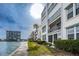 Waterfront condos featuring a seawall, marina, and coastal view at 7645 Sun Island S Dr # 201, South Pasadena, FL 33707