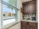 Kitchen wet bar with granite countertop and view of exterior at 7645 Sun Island S Dr # 201, South Pasadena, FL 33707