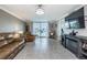 Living room with sliding glass doors to lanai and a cozy fireplace at 7645 Sun Island S Dr # 201, South Pasadena, FL 33707