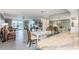 Open living and dining area with views of the water and well appointed furnishings at 7645 Sun Island S Dr # 201, South Pasadena, FL 33707