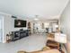 Open-concept living room with modern lighting and views of the kitchen and dining area at 7645 Sun Island S Dr # 201, South Pasadena, FL 33707