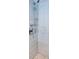 Tiled shower with pebble floor, chrome shower head, and shower handle at 7645 Sun Island S Dr # 201, South Pasadena, FL 33707