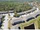 Aerial view showcasing a townhome community with pool, ponds, and lush greenery at 8512 Reedville St, New Port Richey, FL 34654